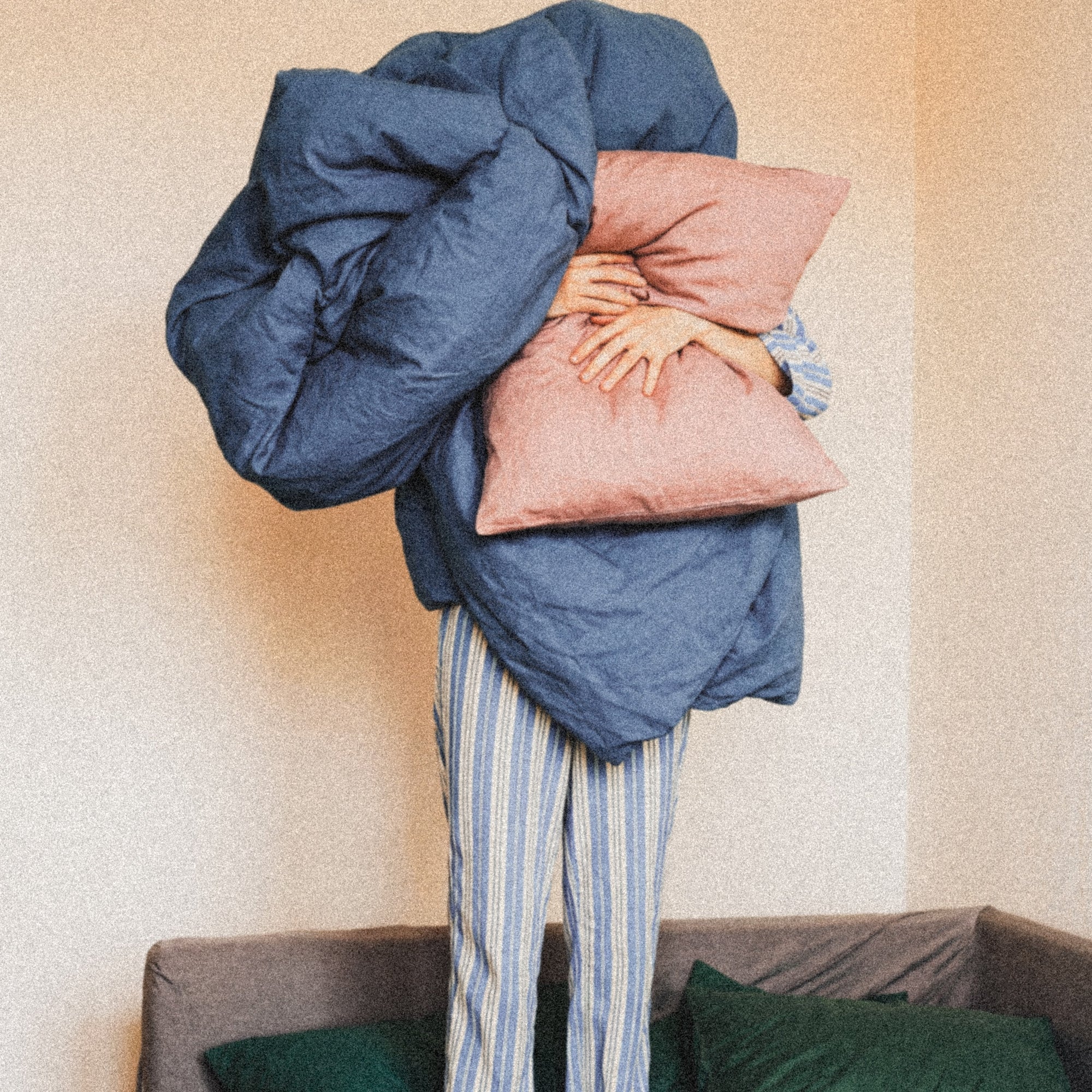 Woman holding duvet cover on sofa