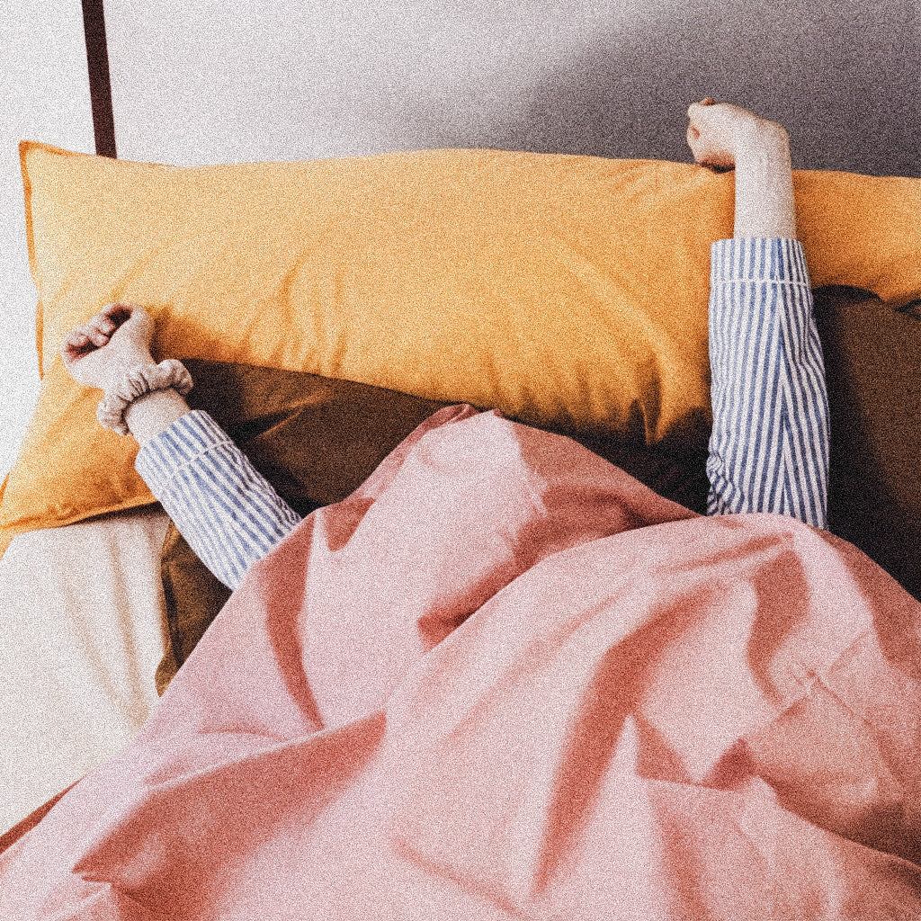 Woman with sheets over head 